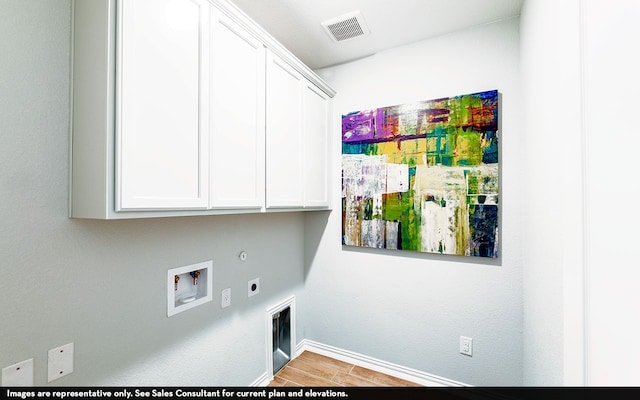 laundry room featuring hookup for a gas dryer, hookup for a washing machine, hookup for an electric dryer, light wood-type flooring, and cabinets