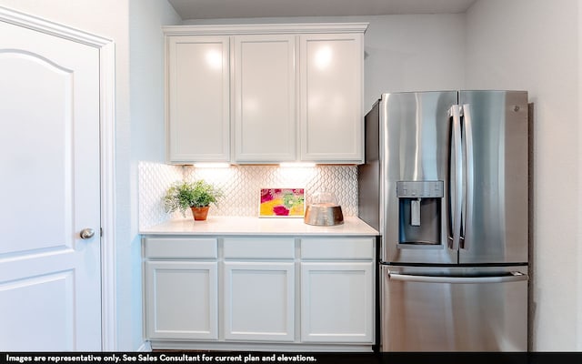 kitchen featuring white cabinets, decorative backsplash, and stainless steel refrigerator with ice dispenser