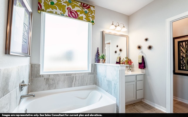 bathroom featuring vanity and a tub to relax in