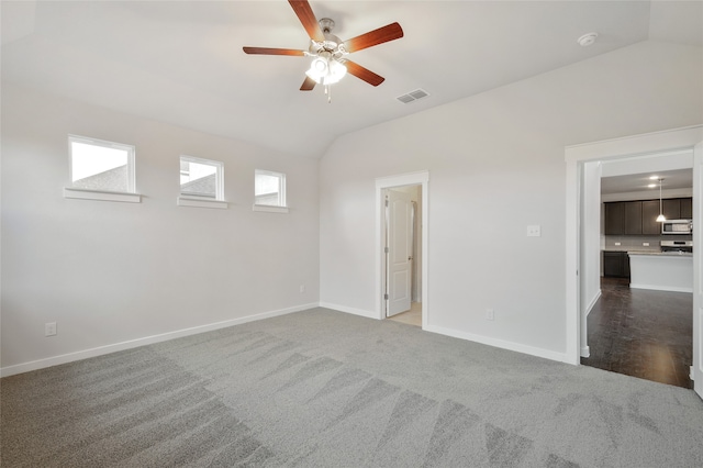 carpeted empty room with lofted ceiling and ceiling fan