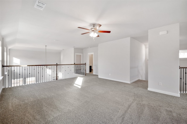 carpeted spare room featuring ceiling fan