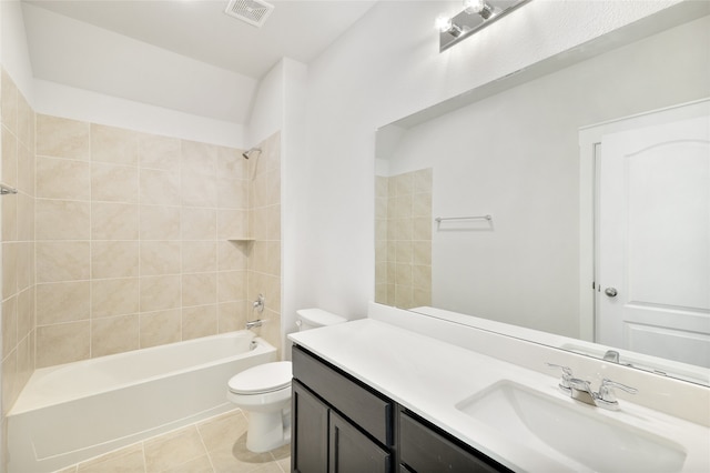 full bathroom with tiled shower / bath, vanity, toilet, and tile patterned flooring