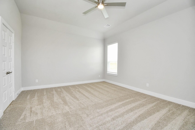 unfurnished bedroom with a ceiling fan, visible vents, vaulted ceiling, baseboards, and carpet floors