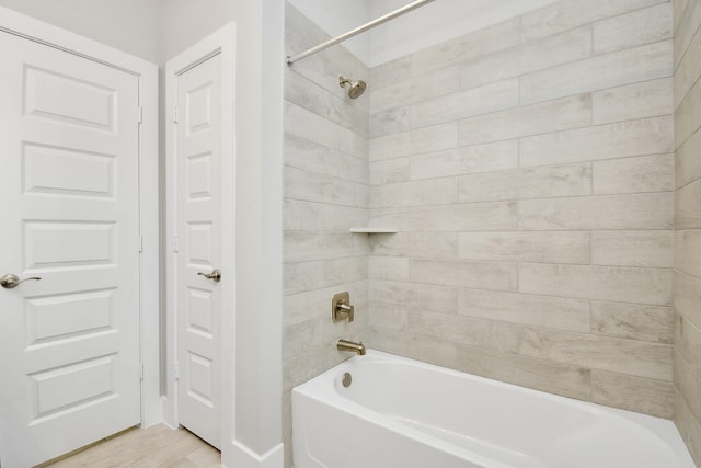 full bath with wood finished floors and shower / bathing tub combination