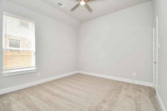 unfurnished room featuring visible vents, ceiling fan, carpet, and plenty of natural light