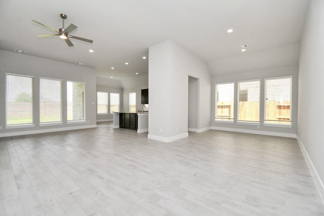 unfurnished living room with baseboards, recessed lighting, a ceiling fan, and light wood-style floors