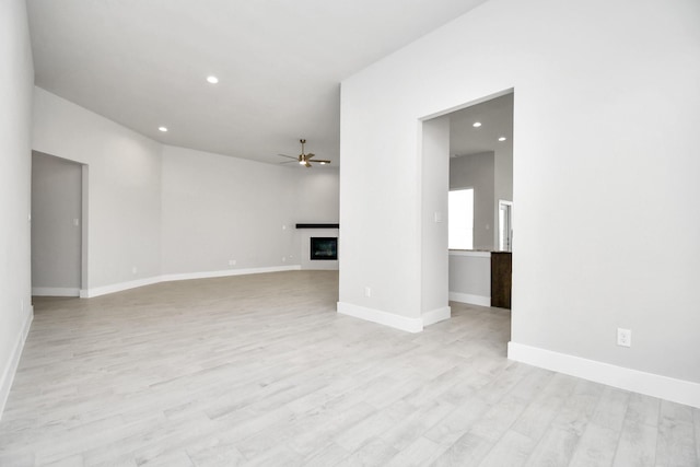 empty room with ceiling fan, recessed lighting, and light wood finished floors