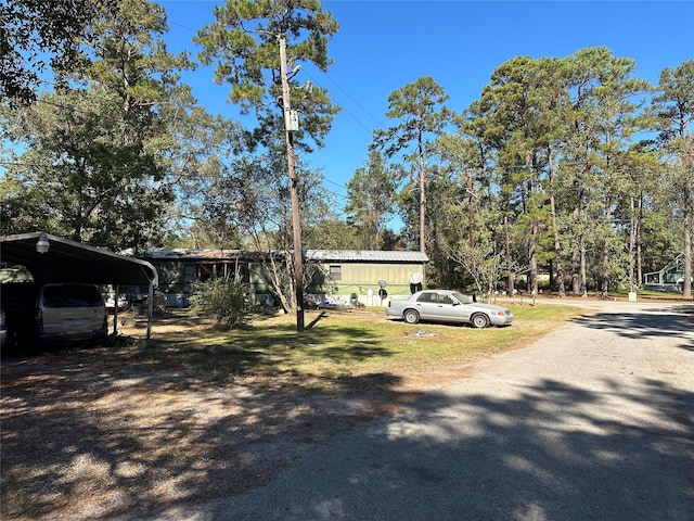 view of front of property featuring a carport and driveway