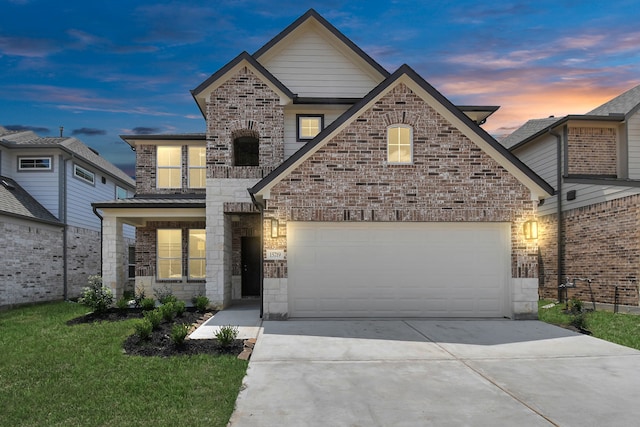 view of front facade featuring a garage and a lawn