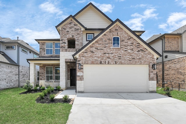 view of property featuring a front yard and a garage