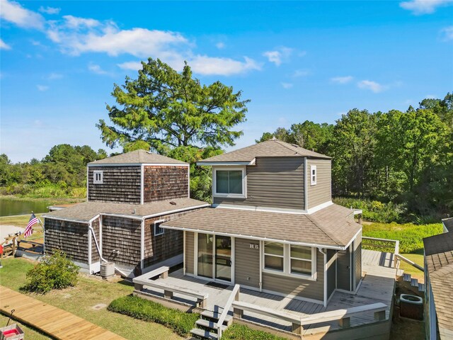 back of house with a deck with water view