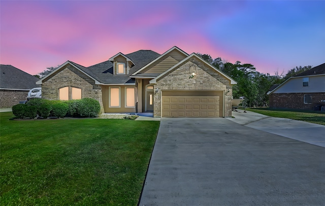 view of front facade with a garage and a lawn