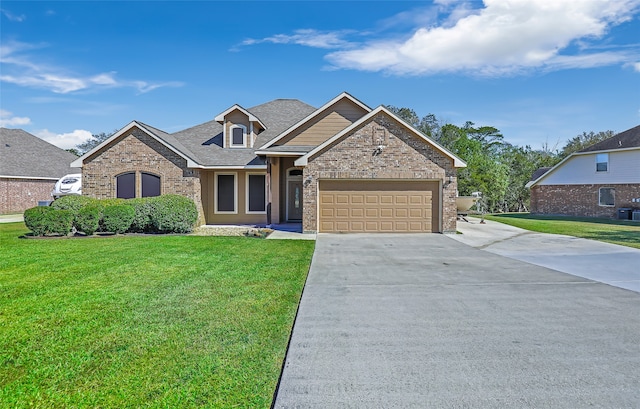 view of front of property with a front yard and a garage