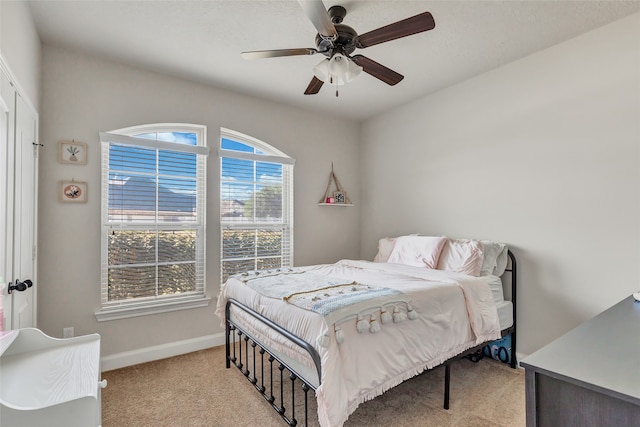 carpeted bedroom with ceiling fan