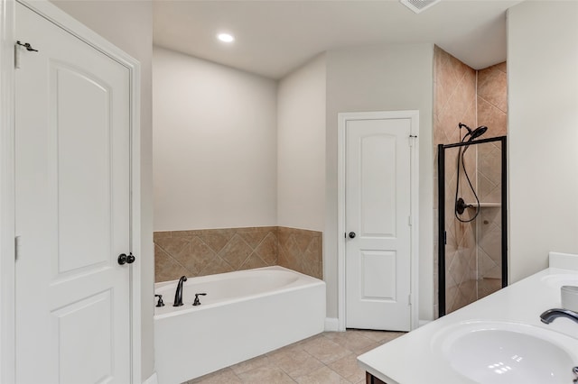 bathroom with vanity, a tub to relax in, and tile patterned floors