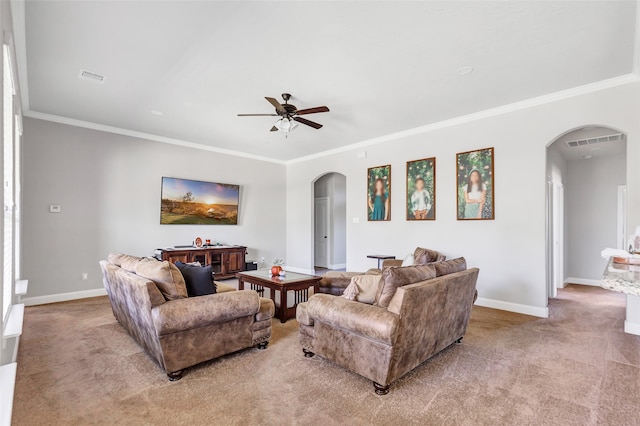 carpeted living room featuring ornamental molding and ceiling fan