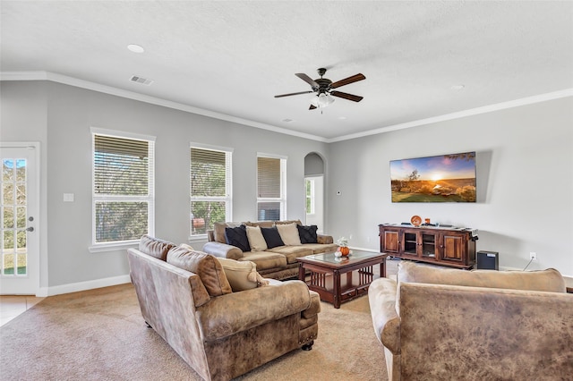 living room featuring crown molding, a textured ceiling, ceiling fan, and a wealth of natural light