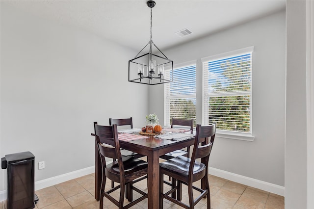 tiled dining area with an inviting chandelier