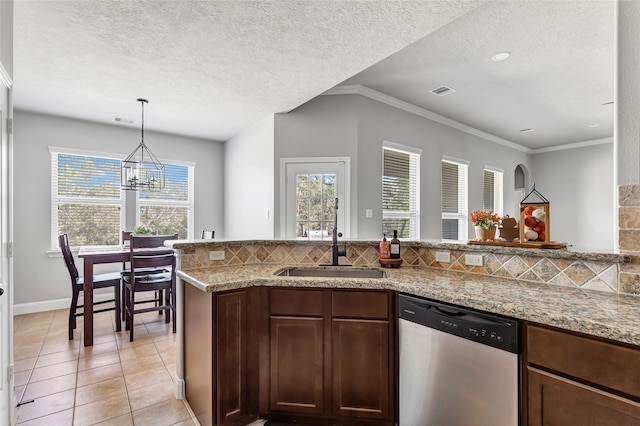 kitchen with stainless steel dishwasher, a textured ceiling, and backsplash