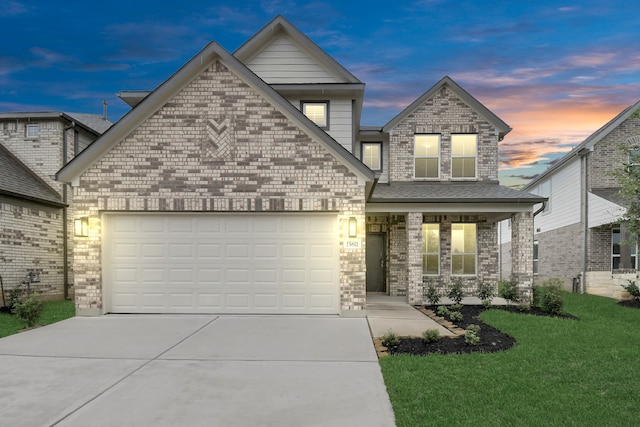 view of front of house with a garage and a lawn