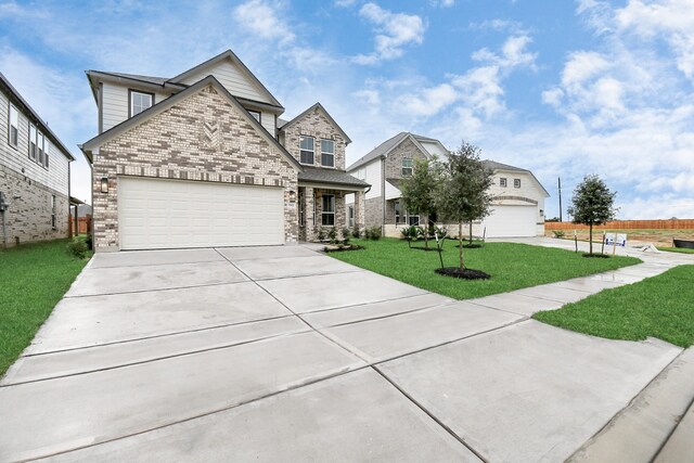 view of front of property with a front yard and a garage