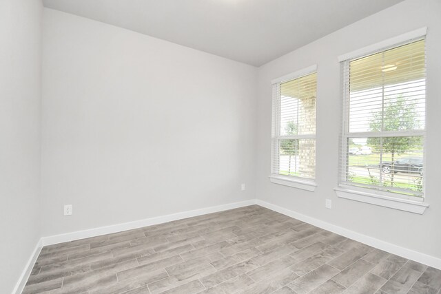 unfurnished room with light hardwood / wood-style flooring