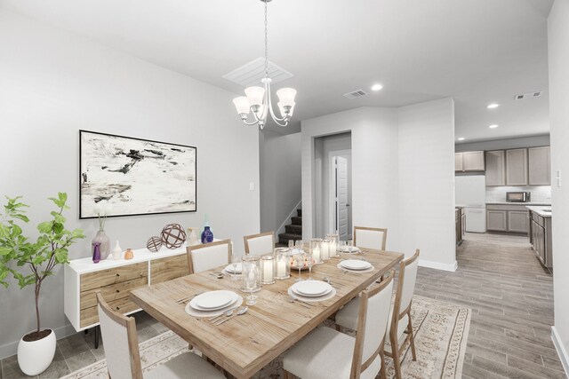 dining space with a chandelier and light wood-type flooring