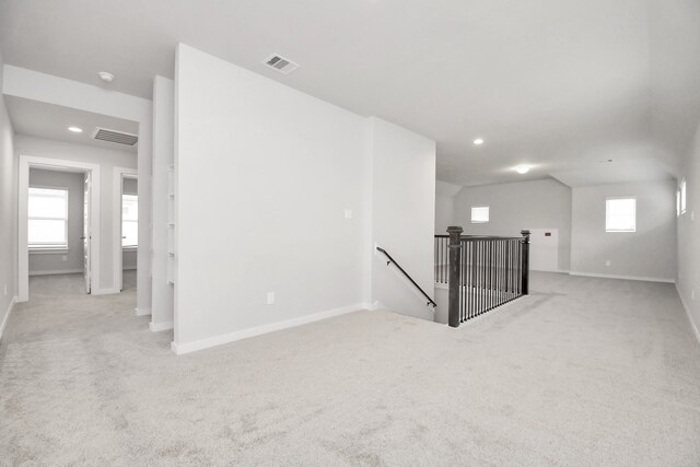 unfurnished room with a healthy amount of sunlight and light colored carpet