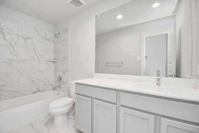 full bathroom with vanity, tiled shower / bath combo, and toilet