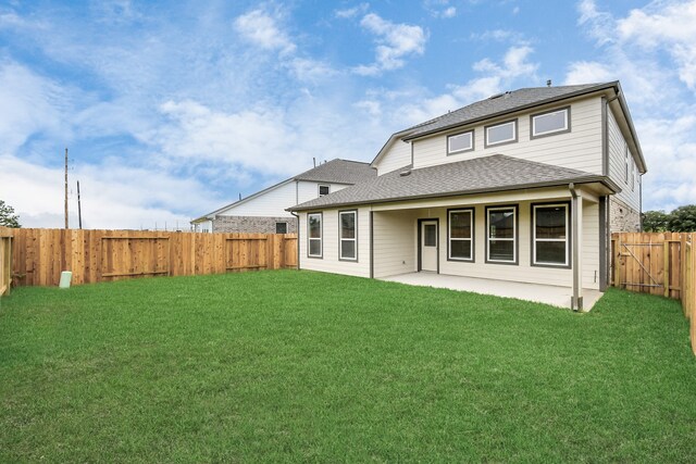 back of property featuring a patio area and a lawn