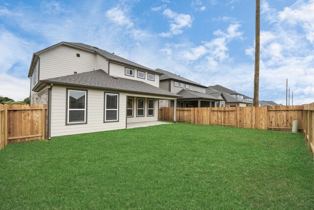 back of house with a yard and a patio area