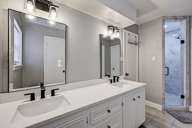 bathroom with vanity, a shower with shower door, and tile patterned flooring