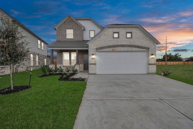 view of front of house with a yard and a garage