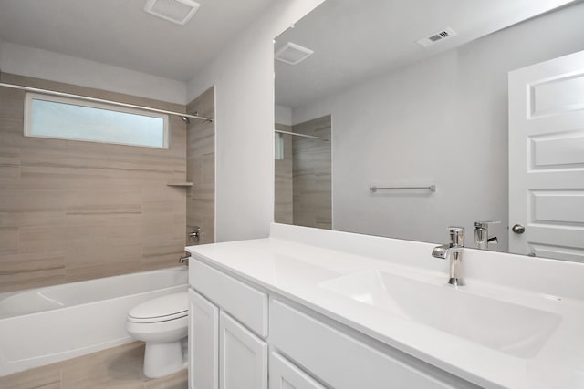 full bathroom with toilet, tiled shower / bath, and vanity