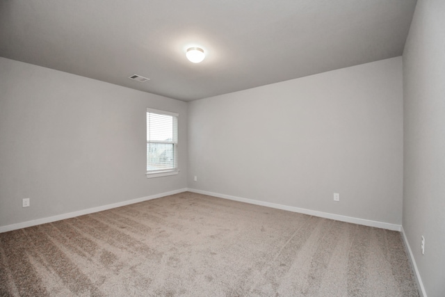 unfurnished room featuring carpet