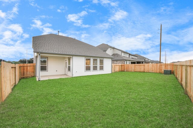 rear view of property featuring a patio area and a yard