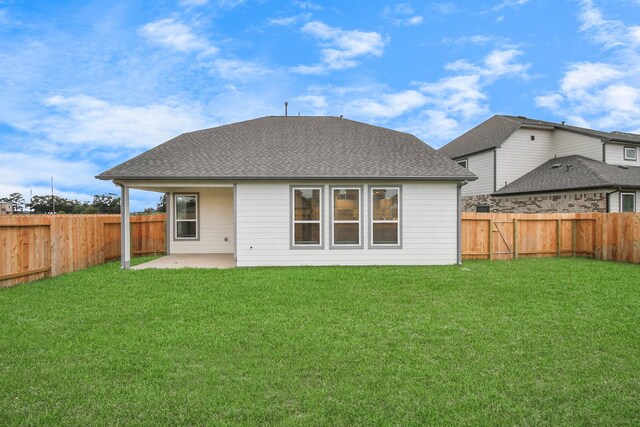 back of house featuring a yard and a patio