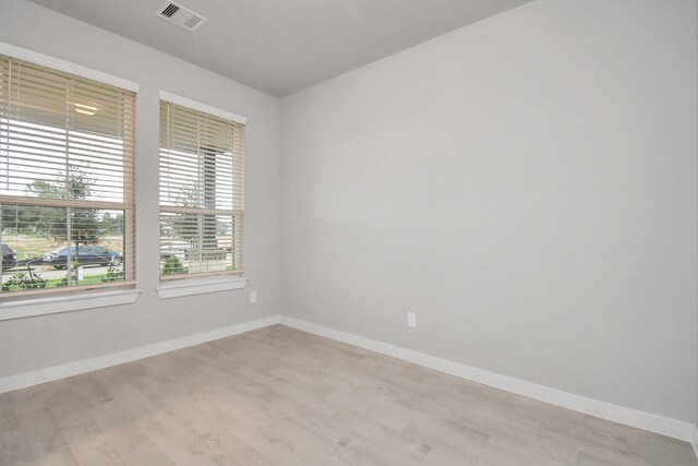 unfurnished room with light hardwood / wood-style floors