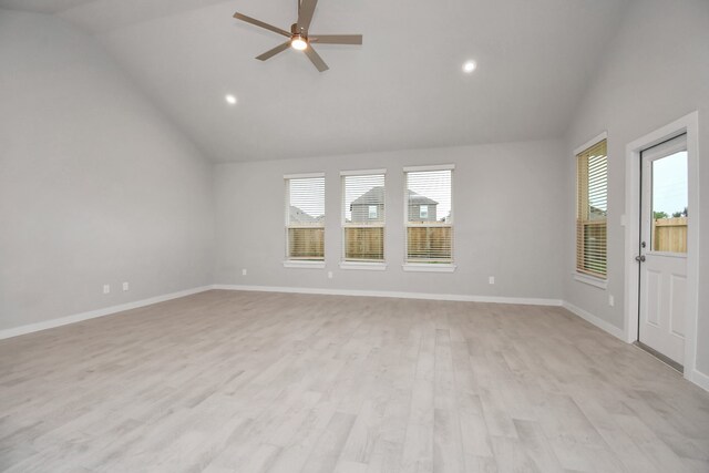 unfurnished living room featuring ceiling fan, vaulted ceiling, and light wood-type flooring