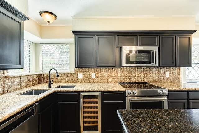 kitchen with wine cooler, sink, stainless steel appliances, and backsplash