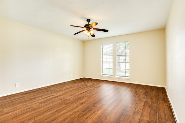 empty room with dark wood-type flooring and ceiling fan