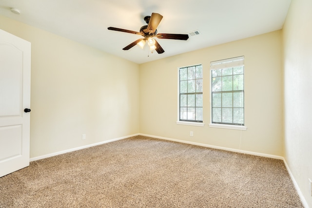 spare room with carpet flooring and ceiling fan