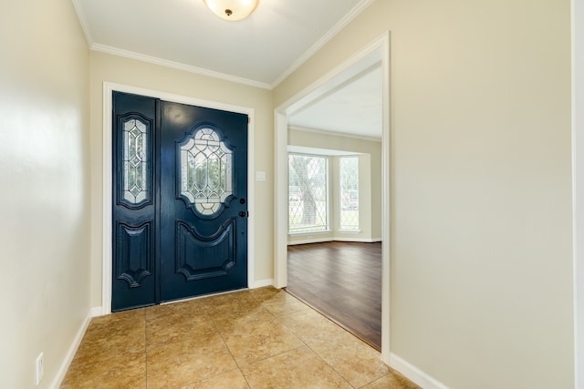 foyer entrance with ornamental molding and light wood-type flooring