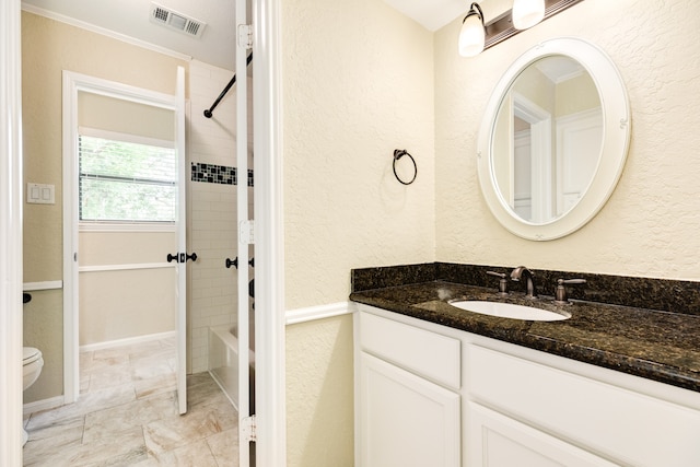 full bathroom with toilet, tiled shower / bath, and vanity