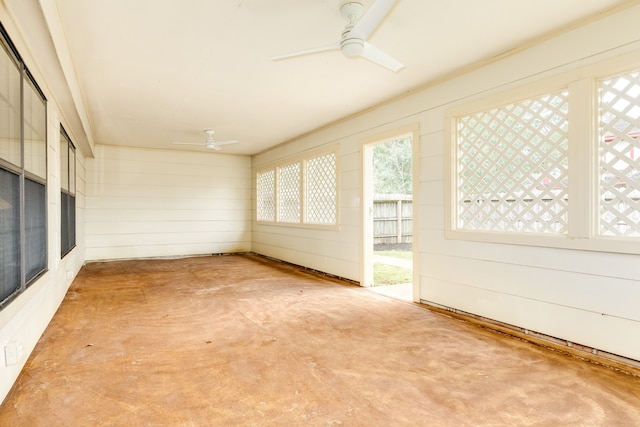 unfurnished sunroom featuring ceiling fan