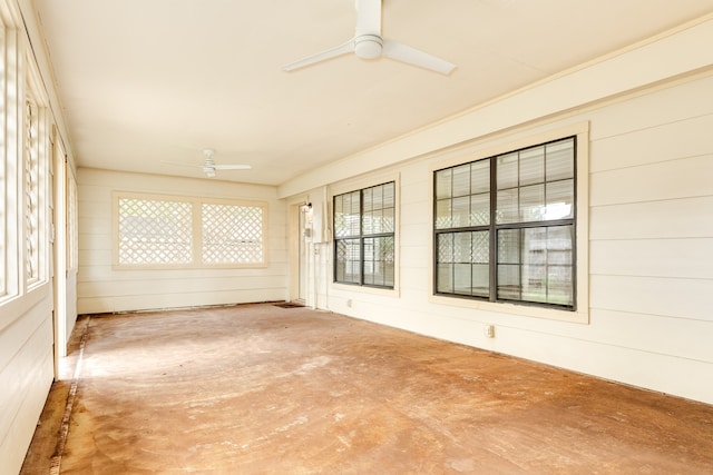 unfurnished sunroom with ceiling fan