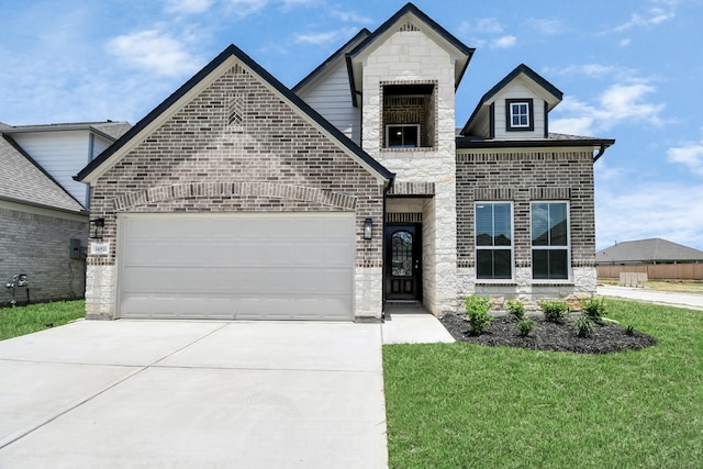 view of front of home featuring a garage and a front lawn