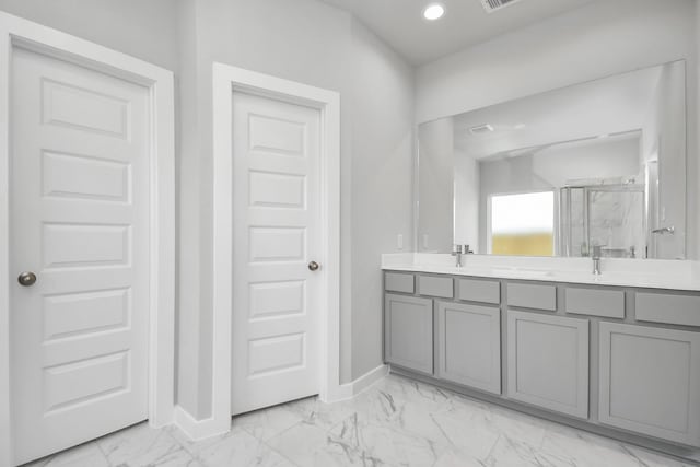 full bath featuring recessed lighting, double vanity, marble finish floor, baseboards, and a stall shower