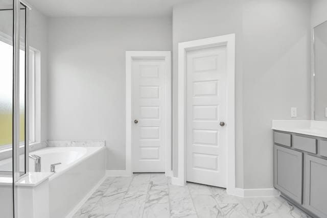 bathroom with vanity and a tub to relax in