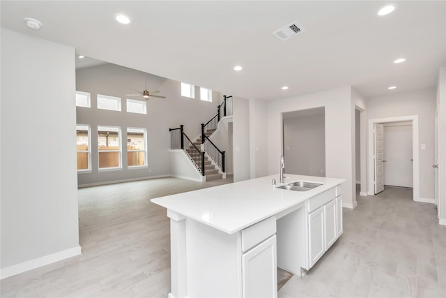 14707 Surfbird Ln, Houston, TX 77049 - kitchen featuring a sink, a ceiling fan, white cabinetry, baseboards, and recessed lighting